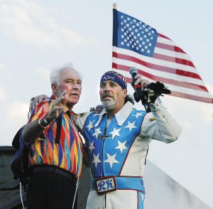Daredevil Evel Knievel and his son and fellow daredevil Robbie Knievel embrace at the top of the landing ramp prior to Robbie's successful 180-ft jump during the fifth annual Evel Knievel Days in Butte, Mont., in this July 28, 2006, file photo. Knievel, left, the hard-living motorcycle daredevil whose exploits made him an international icon in the 1970s, died Friday, Nov. 30, 2007. He was 69. (AP Photo/The Montana Standard, Walter Hinick, file)